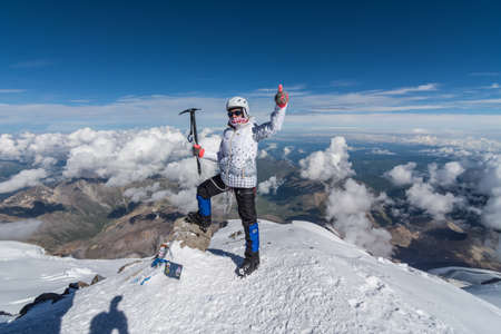 Caucasus / Russia - 07.23.2018 Group of climbers climbing mountain peaks.