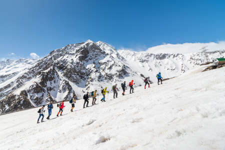 Caucasus / Russia - 22.04.2018 Group of climbers climbing mountain peaks.