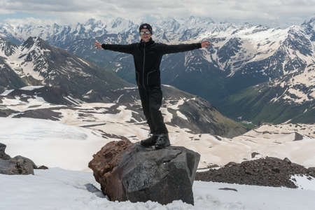 Caucasus / Russia - 02/06/2008 Group of climbers, acclimatization program in the mountains before climbing Mount Elbrus. Tourists take pictures on the background of high snowy mountain peaks.のeditorial素材