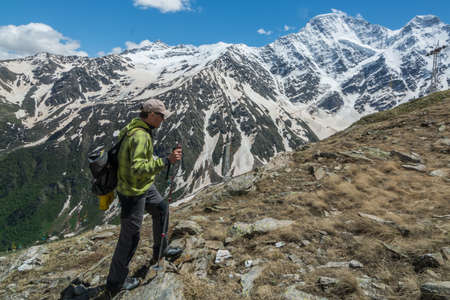 Caucasus / Russia - 02/06/2008 Group of climbers, acclimatization program in the mountains before climbing Mount Elbrus. Tourists take pictures on the background of high snowy mountain peaks.のeditorial素材