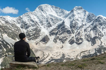Caucasus / Russia - 02/06/2008 Group of climbers, acclimatization program in the mountains before climbing Mount Elbrus. Tourists take pictures on the background of high snowy mountain peaks.のeditorial素材