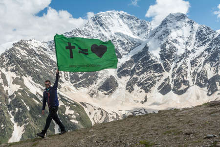 Caucasus / Russia - 02/06/2008 Group of climbers, acclimatization program in the mountains before climbing Mount Elbrus. Tourists take pictures on the background of high snowy mountain peaks.のeditorial素材