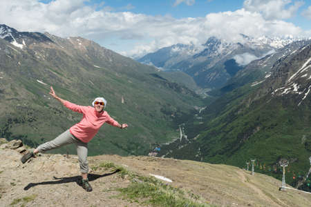 Caucasus / Russia - 02/06/2008 Group of climbers, acclimatization program in the mountains before climbing Mount Elbrus. Tourists take pictures on the background of high snowy mountain peaks.のeditorial素材