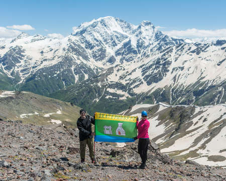 Caucasus / Russia - 02/06/2008 Group of climbers, acclimatization program in the mountains before climbing Mount Elbrus. Tourists take pictures on the background of high snowy mountain peaks.のeditorial素材