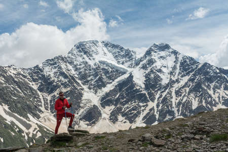 Caucasus / Russia - 22/06/2008 Group of climbers, acclimatization program in the mountains before climbing Mount Elbrus. Tourists take pictures on the background of high snowy mountain peaks.のeditorial素材