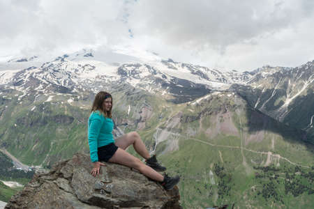 Caucasus / Russia - 02/06/2008 Group of climbers, acclimatization program in the mountains before climbing Mount Elbrus. Tourists take pictures on the background of high snowy mountain peaks.のeditorial素材