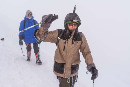 Caucasus / Russia - 07/31/2018 Group of climbers climbing mountain peaks.のeditorial素材
