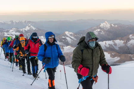 Caucasus / Russia - 09/09/2018 Group of climbers climbing mountain peaks