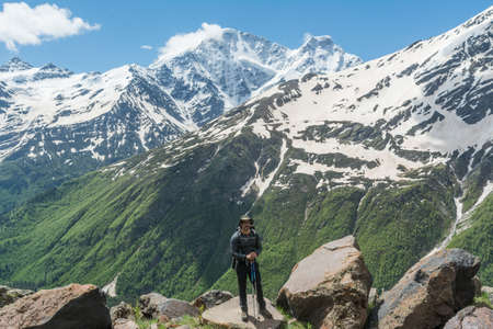 Caucasus / Russia - 02/06/2008 Group of climbers, acclimatization program in the mountains before climbing Mount Elbrus. Tourists take pictures on the background of high snowy mountain peaks.のeditorial素材