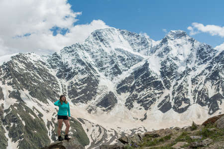 Caucasus / Russia - 02/06/2008 Group of climbers, acclimatization program in the mountains before climbing Mount Elbrus. Tourists take pictures on the background of high snowy mountain peaks.のeditorial素材