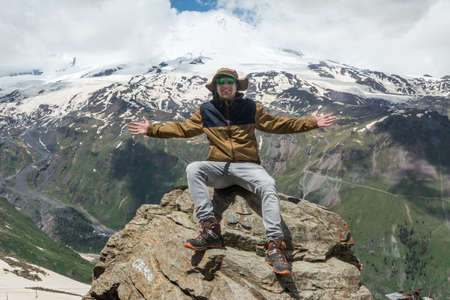 Caucasus / Russia - 02/06/2008 Group of climbers, acclimatization program in the mountains before climbing Mount Elbrus. Tourists take pictures on the background of high snowy mountain peaks.のeditorial素材