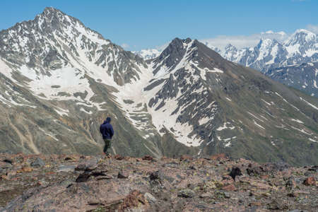 Caucasus / Russia - 02/06/2008 Group of climbers, acclimatization program in the mountains before climbing Mount Elbrus. Tourists take pictures on the background of high snowy mountain peaks.のeditorial素材