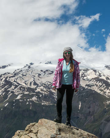 Caucasus / Russia - 02/06/2008 Group of climbers, acclimatization program in the mountains before climbing Mount Elbrus. Tourists take pictures on the background of high snowy mountain peaks.のeditorial素材