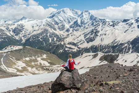 Caucasus / Russia - 02/06/2008 Group of climbers, acclimatization program in the mountains before climbing Mount Elbrus. Tourists take pictures on the background of high snowy mountain peaks.のeditorial素材