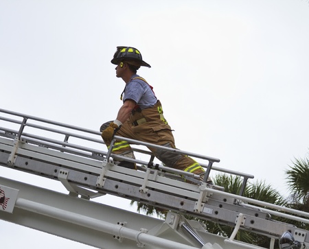 fireman at scene on ladderの写真素材