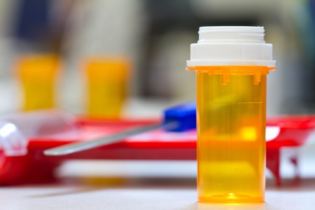 pharmacy vial and cap with pharmacy backgroundの写真素材