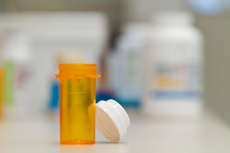 pharmacy vial and cap with pharmacy backgroundの写真素材