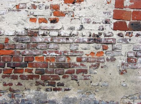 crannied plaster on red brick wallの写真素材