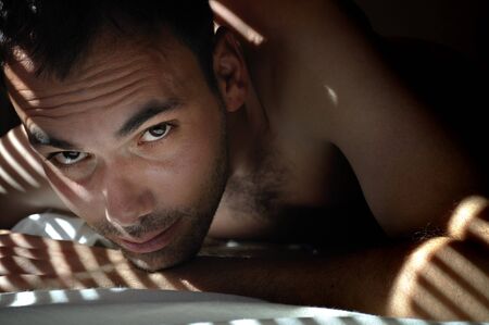 Attractive young man portrait in special lighteningの写真素材