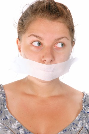 young female with tape on her mouth isolated on white backgroundの写真素材