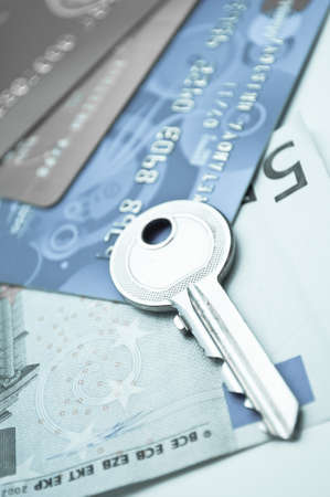key and credit cards over moneyの写真素材