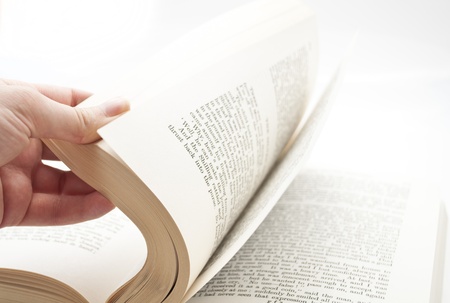 turning over the pages of a bookの写真素材