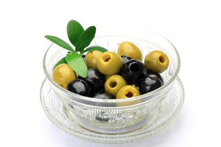 I put  green olive and black olive in a glasswork and I took it in a white background の写真素材