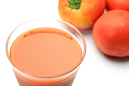 I took tomato juice and  tomato in a white background.の写真素材