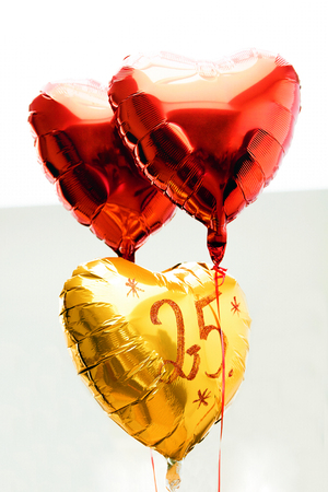 Celebrating 25th years anniversary golden label with ribbon and balloons,の写真素材