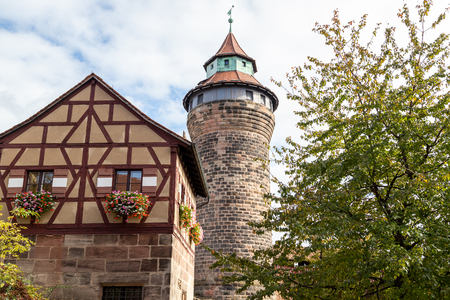 Historic tower and timbered house (frame house) of the Nuremberg castle, Bavaria, Germany  in autunm on a sunny dayのeditorial素材