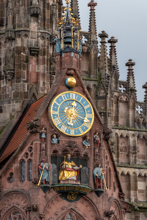 Close up of the clock and other details from the Frauenkirche (woman church) in Nuremberg, Bavaria, Germanyのeditorial素材