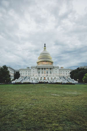 The United States Capitol in Washington DC during sunset on a cloudy dayの写真素材