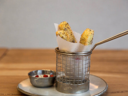 Crispy crackers in a metal basket on a wooden table