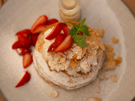 Meringue cake with strawberries and mint. Selective focus.
