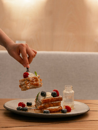 Layered pancake slices on a white plate, dessert photography on a wooden table, minimal background...