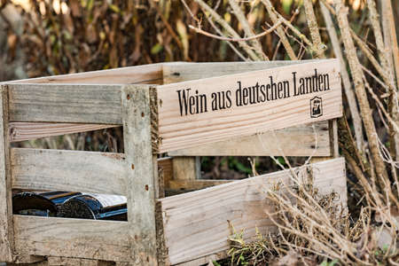 An old wooden box lies in the nature with wine from Germanyの写真素材