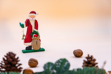 Decorative card with Santa Claus, nuts and a pine branch and space for your own text on a beige backgroundの写真素材