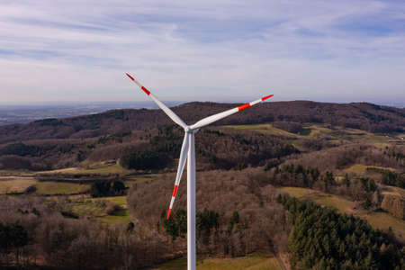 Aerial view of a wind turbine with red and white propellersの写真素材