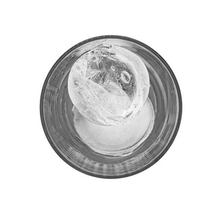 High contrast top view of a clear glass with two round ice cubes isolated on white backgroundの写真素材