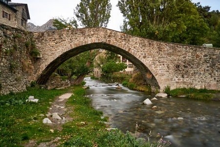 Roman bridge over river of rapid waterの写真素材