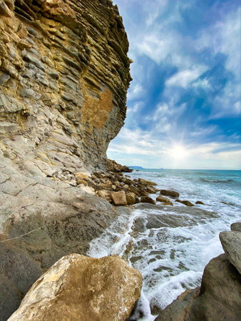 watching beautiful sunrise on the beach with rocksの写真素材