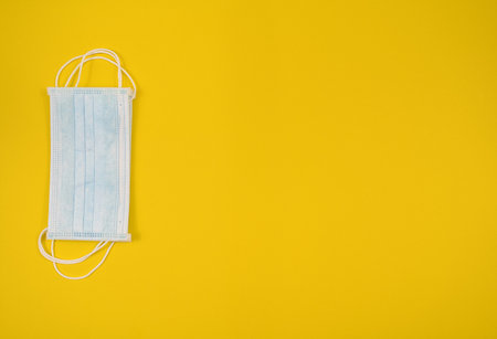 Surgical mask with rubber ear straps. Typical 3-ply surgical mask to cover the mouth and nose. Procedure mask from bacteria. Protection concept, Spainの写真素材