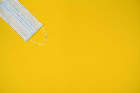 Surgical mask with rubber ear straps. Typical 3-ply surgical mask to cover the mouth and nose. Procedure mask from bacteria. Protection concept, Spainの写真素材