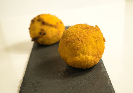 Italian appetizer arancini, rice balls stuffed with meat cooked in deep fat, italian foodの写真素材