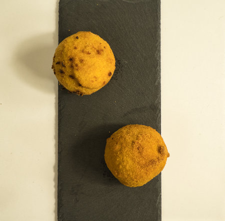 Italian appetizer arancini, rice balls stuffed with meat cooked in deep fat, italian foodの写真素材