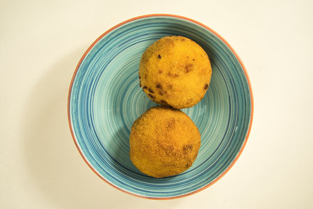 Italian appetizer arancini, rice balls stuffed with meat cooked in deep fat, italian foodの写真素材