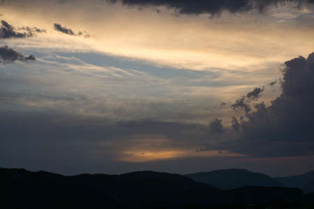 beautiful sunset in a rural house with mountains behind, in the Aragonese Pyrenees, located in Gerbe, Huesca, Spain. With cloudsの写真素材
