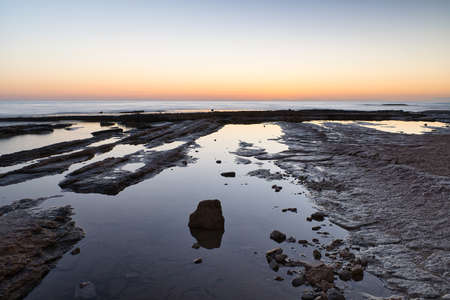 beautiful sunrise on the beach with rocks, located in Alicante, Spain. Viewの写真素材