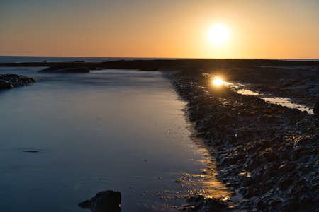 beautiful sunrise on the beach with rocks, located in Alicante, Spain. View