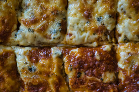 Delicious homemade hot Italian pizza ready to eat. With tomato, ham, mozzarella cheese and four cheeses. Tasteの写真素材